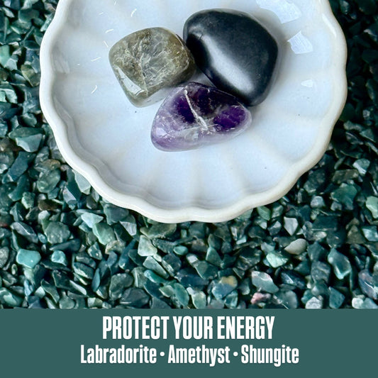 Shell with Labradorite, Amethyst, and Shungite stones on a green stone background with text 'Protect Your Energy'.