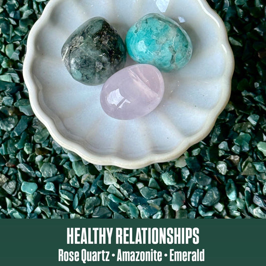Three crystals (Rose Quartz, Amazonite, Emerald) in a white dish on a green stone background with text 'Healthy Relationships'.