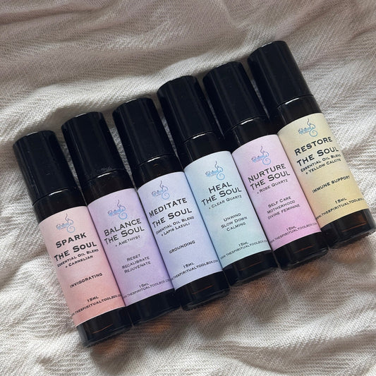 Set of rollerball bottles with various labels on a textured fabric background