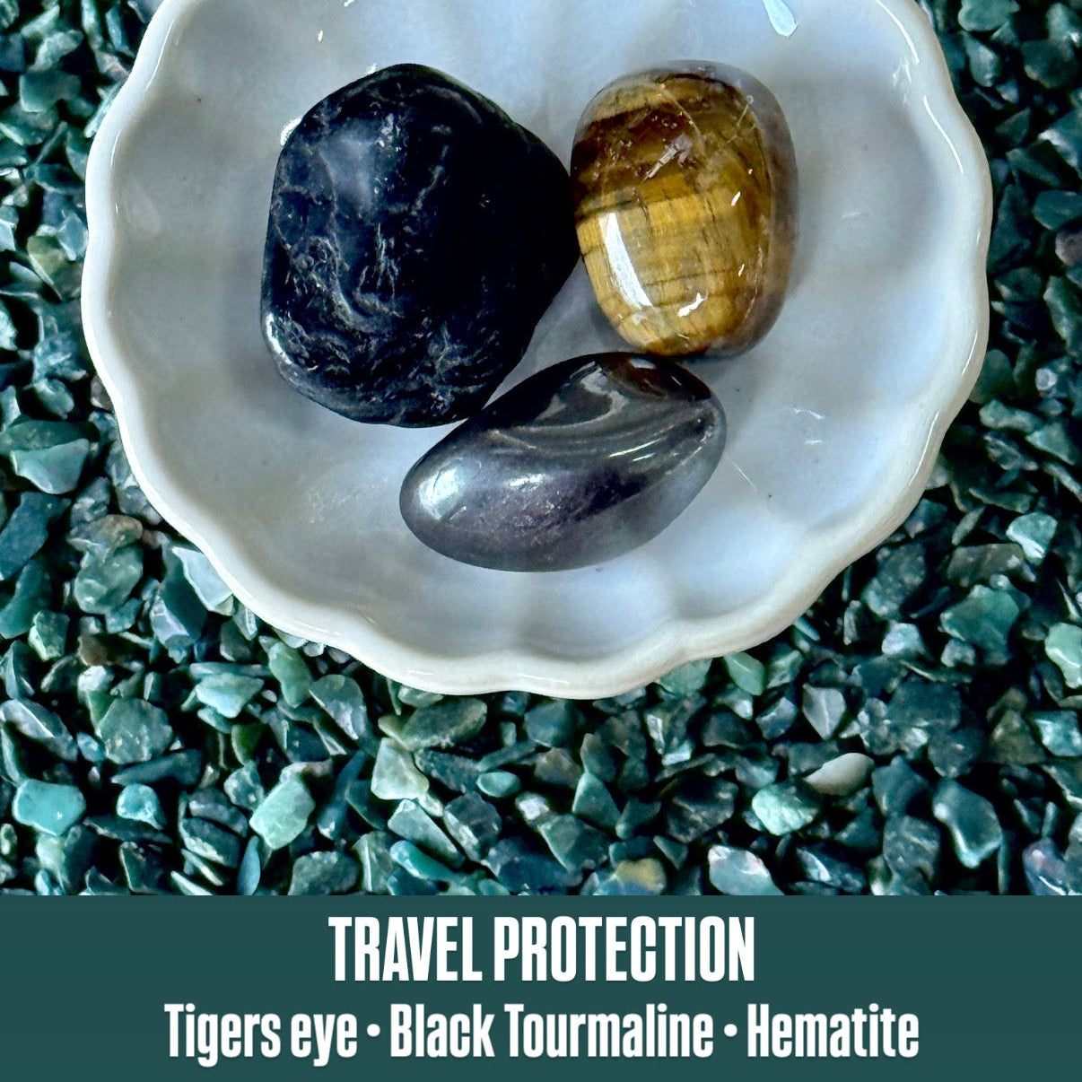Three stones (Tigers eye, Black Tourmaline, Hematite) in a white shell on a textured green surface with text 'Travel Protection'.