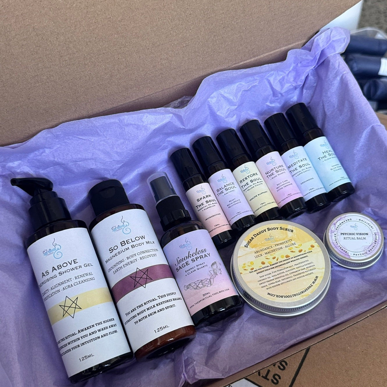 Collection of skincare products in a box with a purple interior