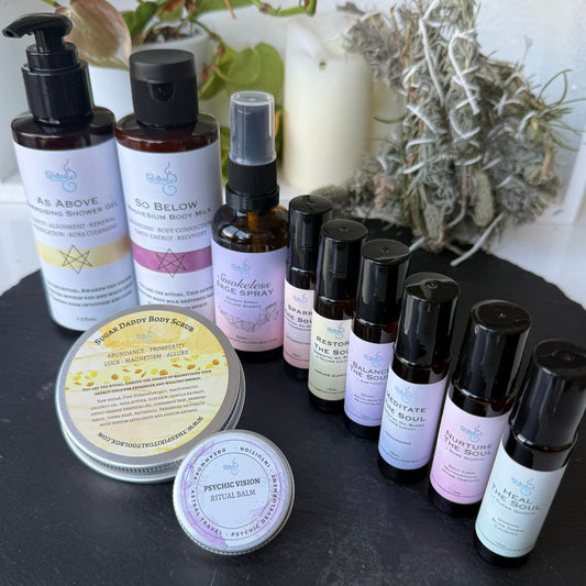 Collection of skincare products on a dark surface with plants in the background