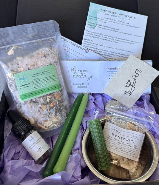 Assorted items including a bowl, herbs, and packets on a black surface.